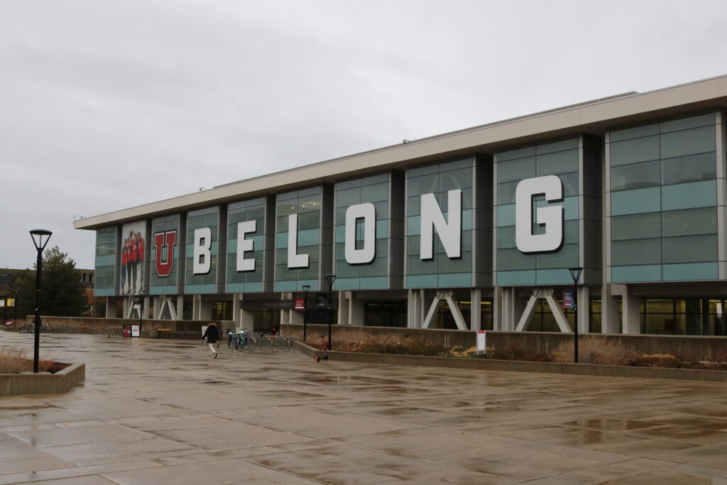 A large sign on a building reads U BELONG